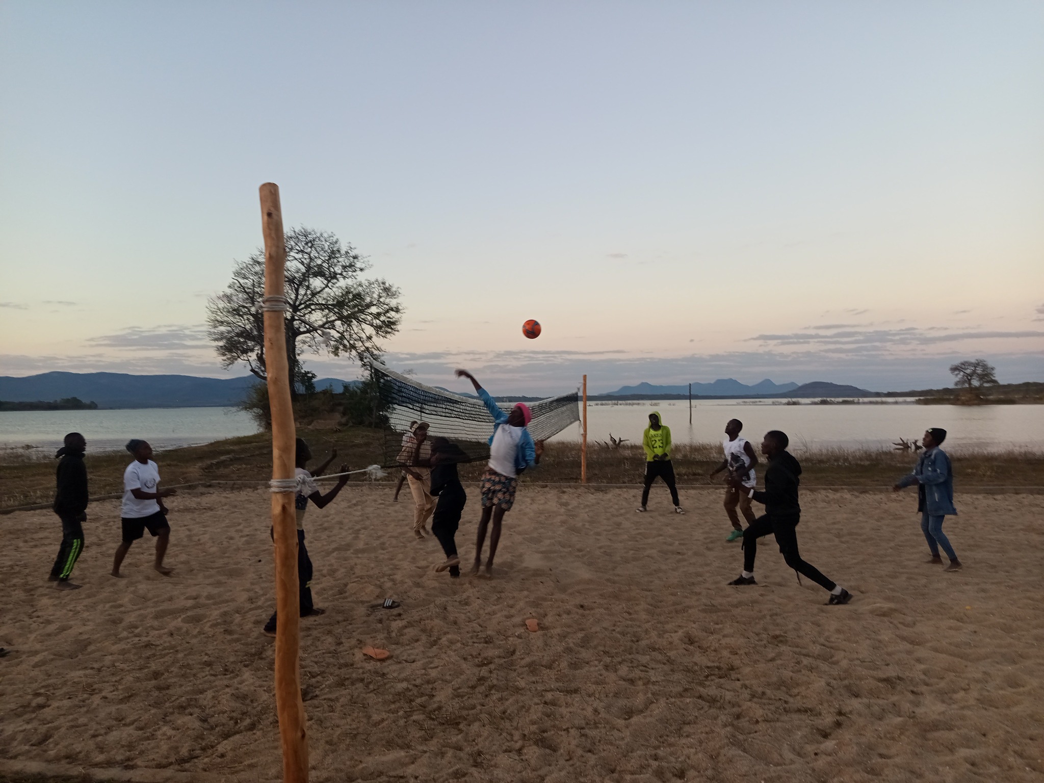 Volleyball game at sunset